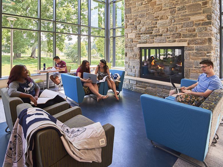 Students sitting by the fire in the Fireside Lounge