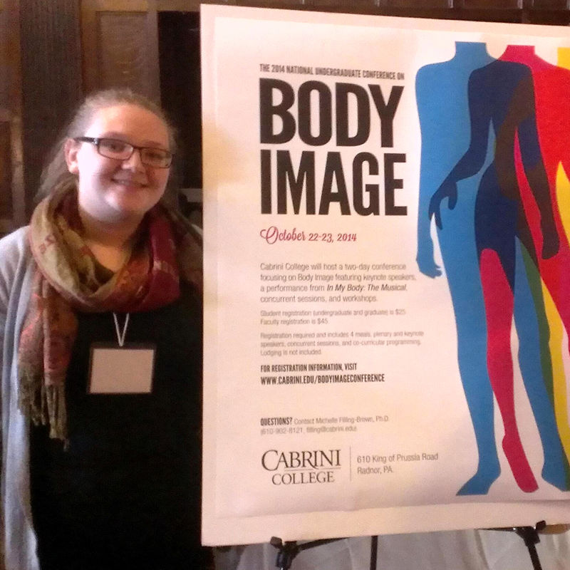 Megan Griffith standing next to her poster