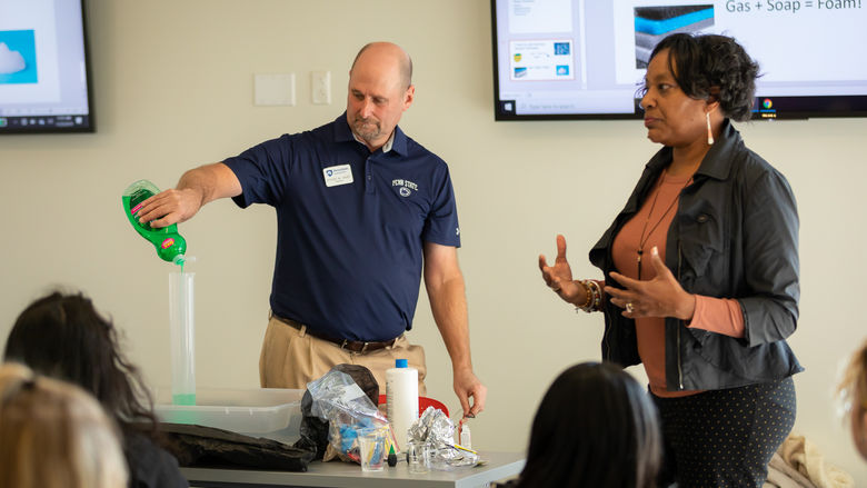 Penn State Brandywine faculty conduct a chemistry experiment for high school girls.