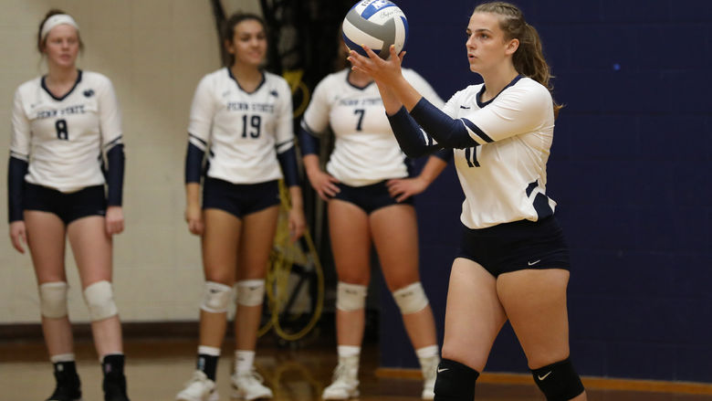 Penn State Brandywine first-year student Lexie Berry prepares to serve during a volleyball match.