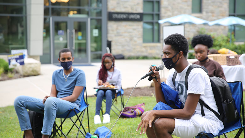 Brandywine students having discussion on the campus lawn.