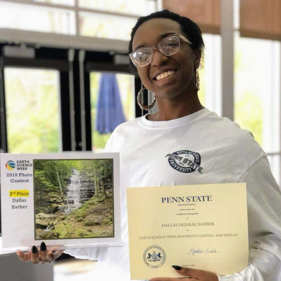 Dallas Barber displays her photo entry at the 2019 Earth Science Week Photo Contest. 