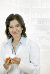 woman in white medical coat holding prescription bottles