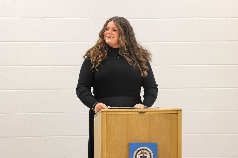 Brandi speaking at a podium