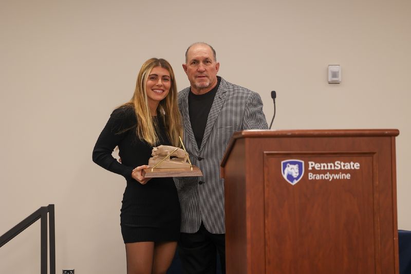 Arianna Segich and Mark Caserta posing with award