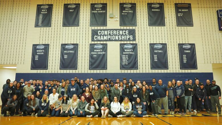 Student-athletes pose for a photo in Penn State Brandywine's gym.