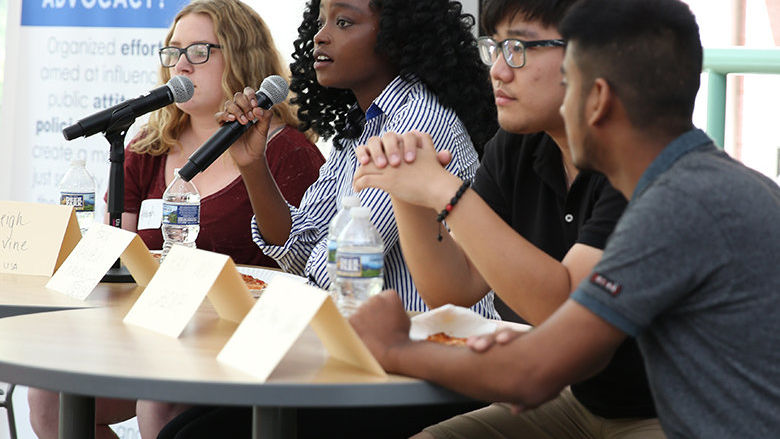 Students speaking on a panel.