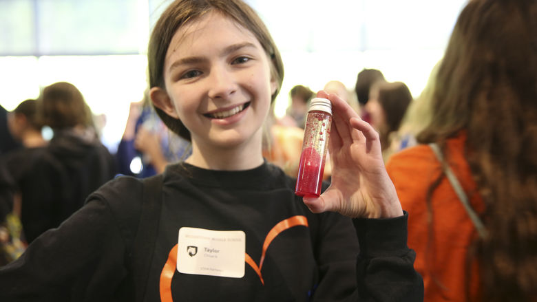 Student holding a make your own test tube lava lamps