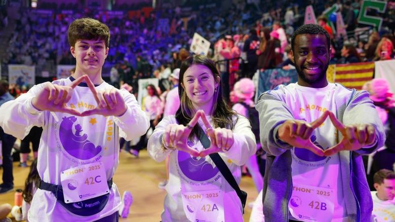 people standing with hands in diamond shape