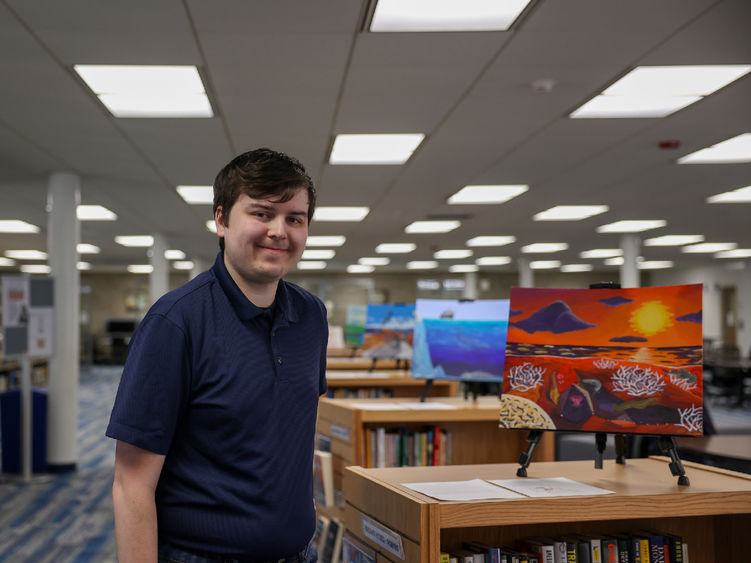 Jacob Campbell standing next to his painting