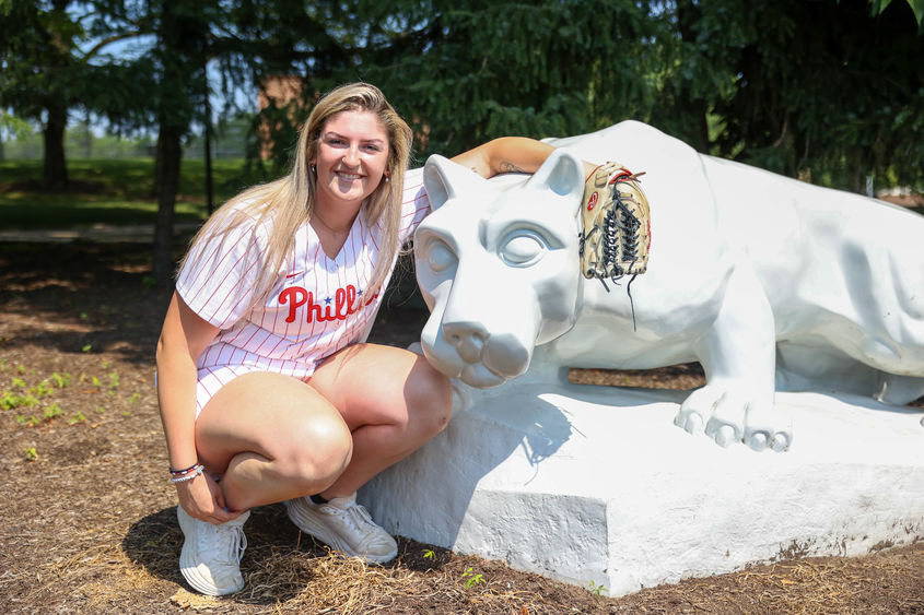 Farrell Everett in Phillies uniform with glove next to Nittany Lion