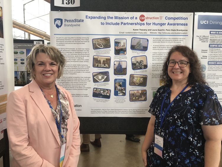 Brandywine Professor of Earth Sciences Laura Guertin and Lecturer in Communications Karen Theveny stand in front of their poster at the AASHE conference. 