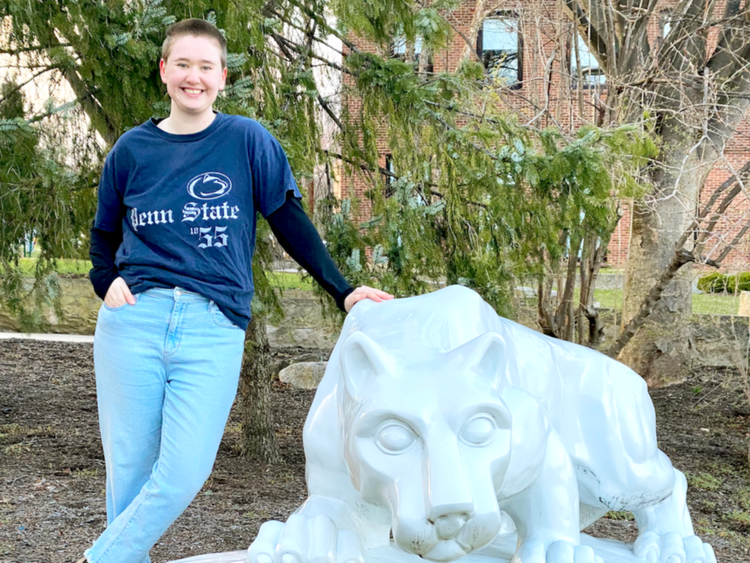 Gracie Guerin standing next to Nittany Lion statue, Penn State's mascot